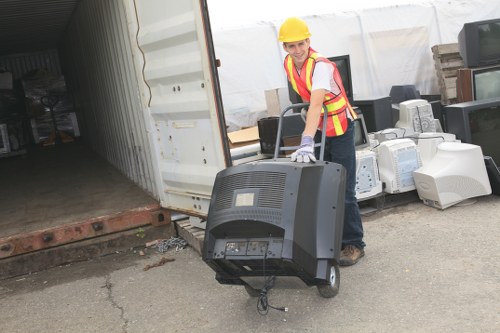 Volunteers loading reused garden furniture for charity distribution